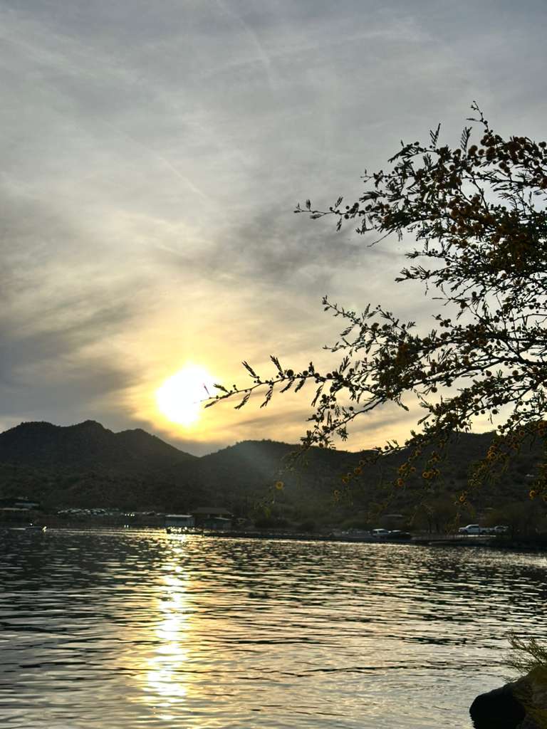 Sunset reflecting over the lake with desert hills