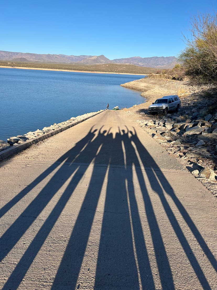 Long shadows cast by sunset near the water