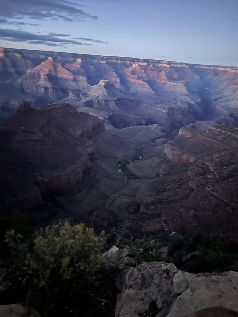 Deep canyon ridges under a fading purple sky