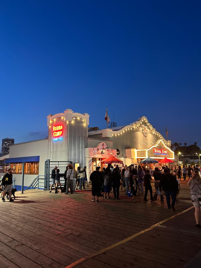 Crowds outside Bubba Gump restaurant at Santa Monica Pier during evening