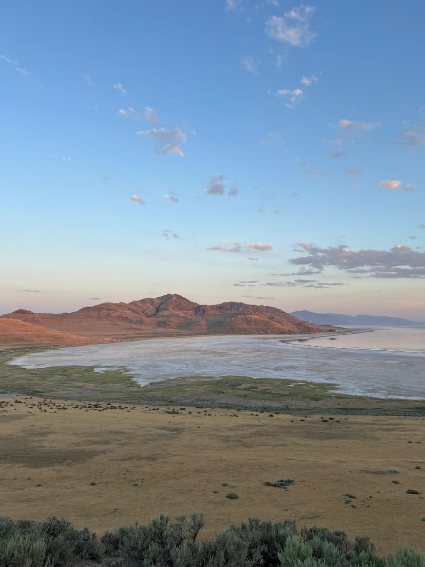 Serene landscape view of Antelope Island with lake and mountains at dusk