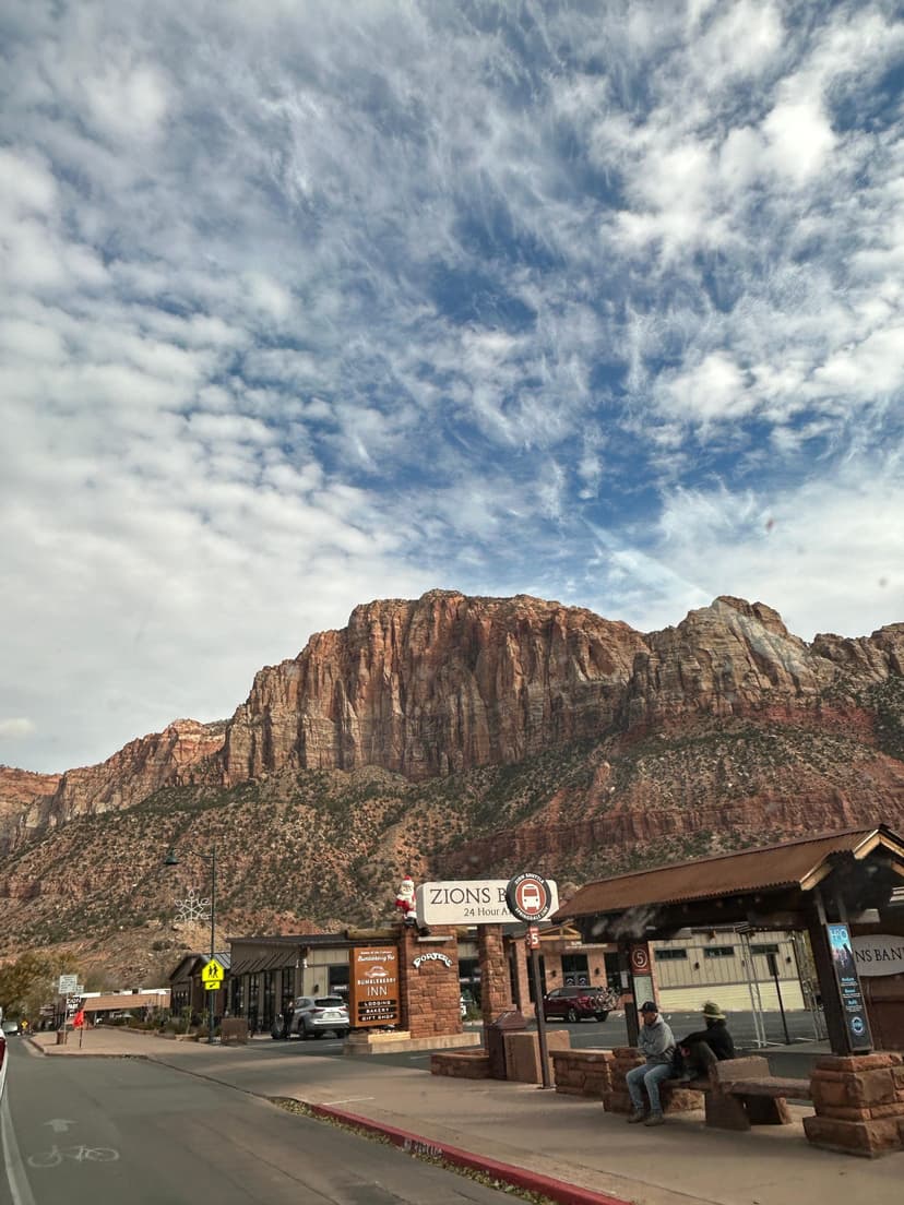 Zion National Park town with red rock cliffs and cloudy blue sky