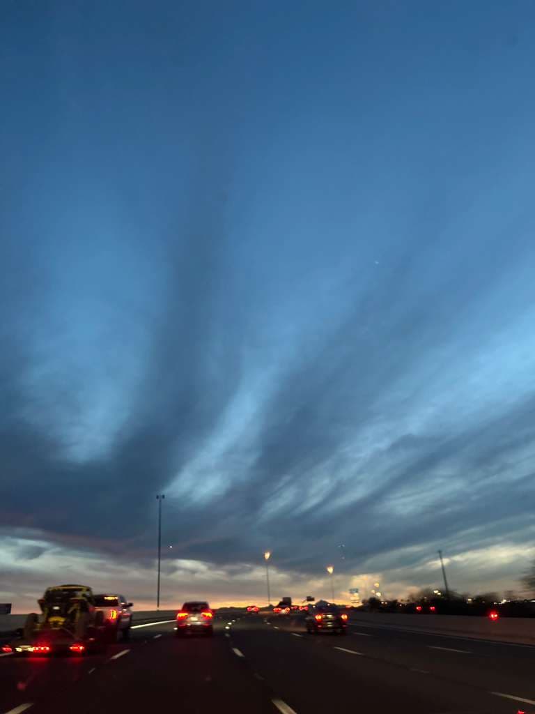 Evening highway drive under soft blue skies