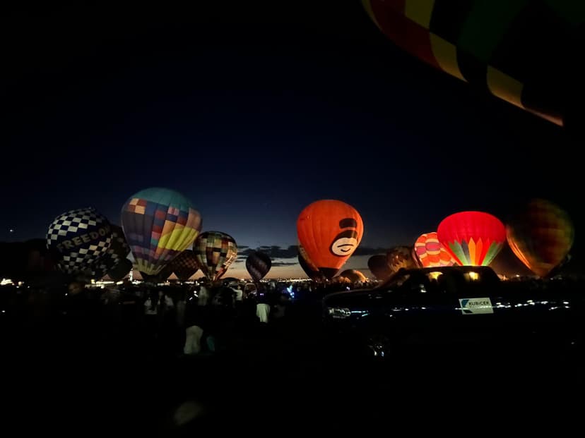 Hot air balloons glowing at night during a Las Vegas balloon festival